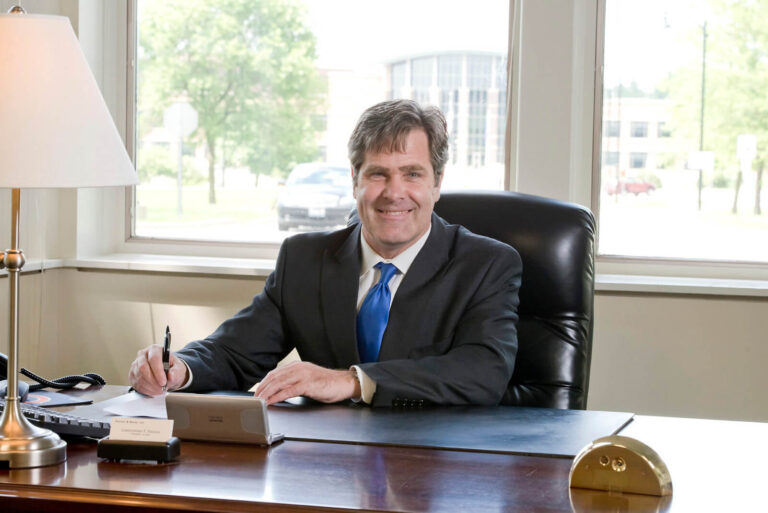 chris working smiling with jacket 768x513