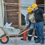 Workers compensation attorney Denver CO  construction workers assisting injured coworker at job site